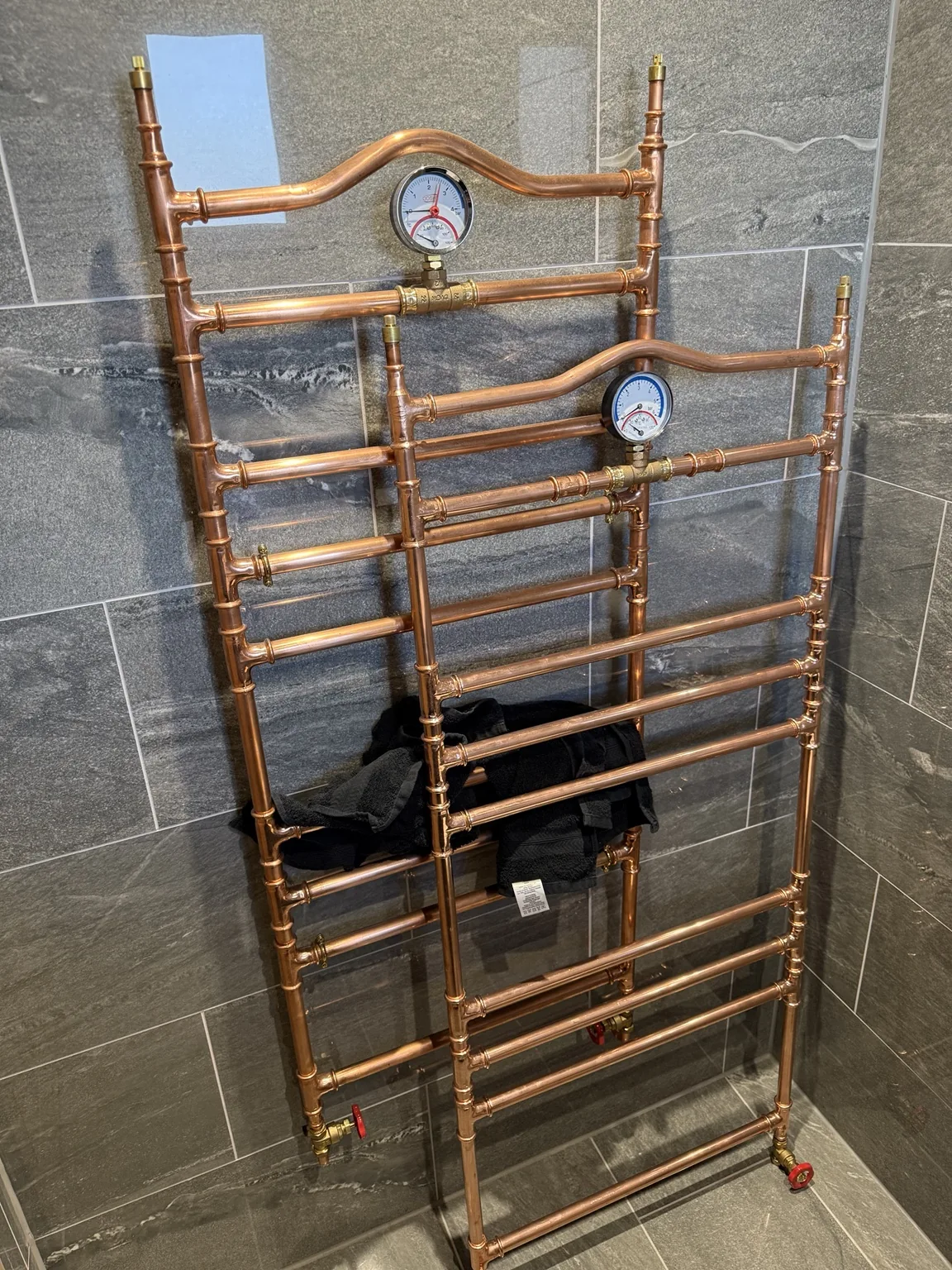 Chrome heated towel rail installation