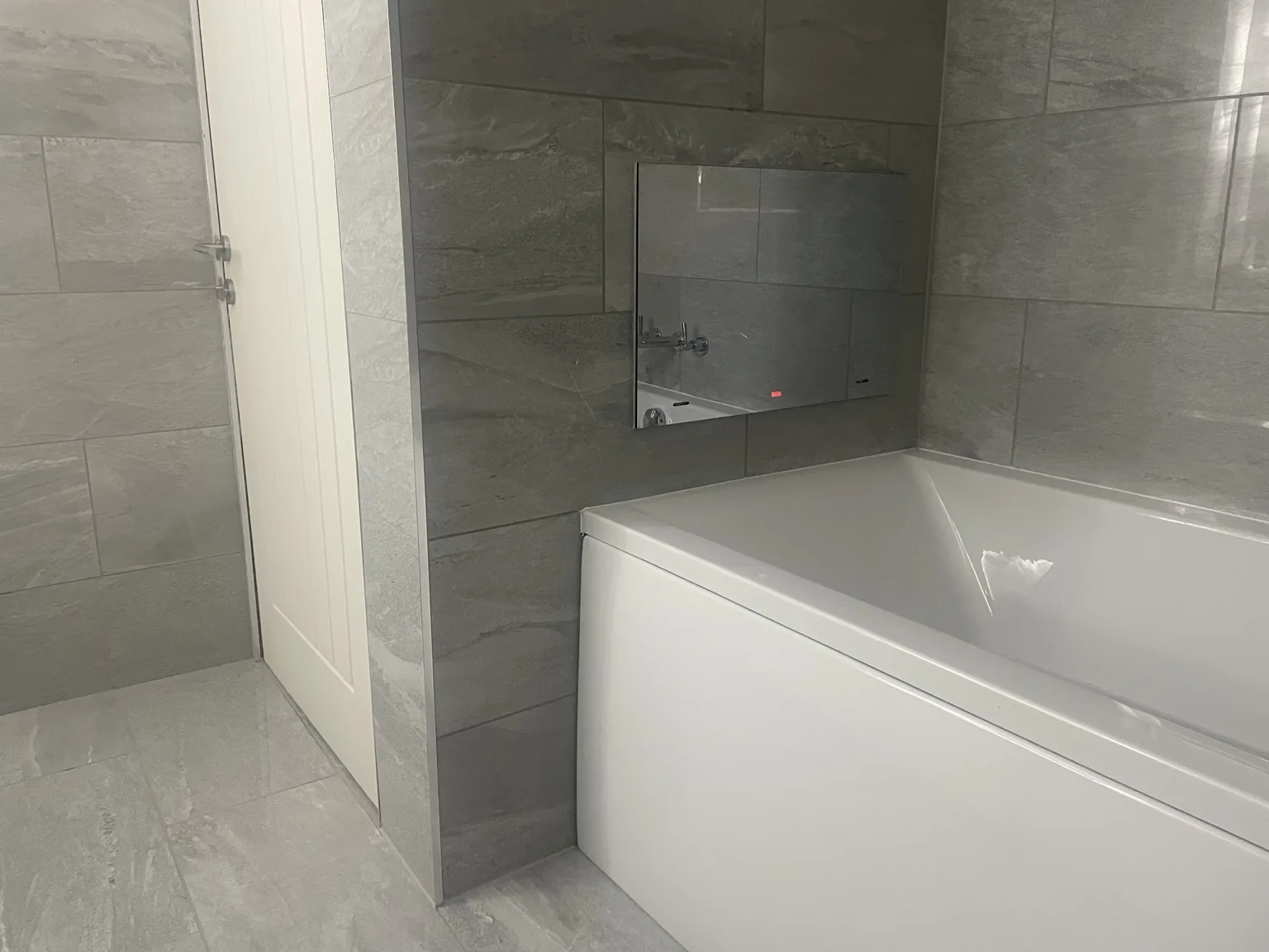 Bath installation in a tiled bathroom