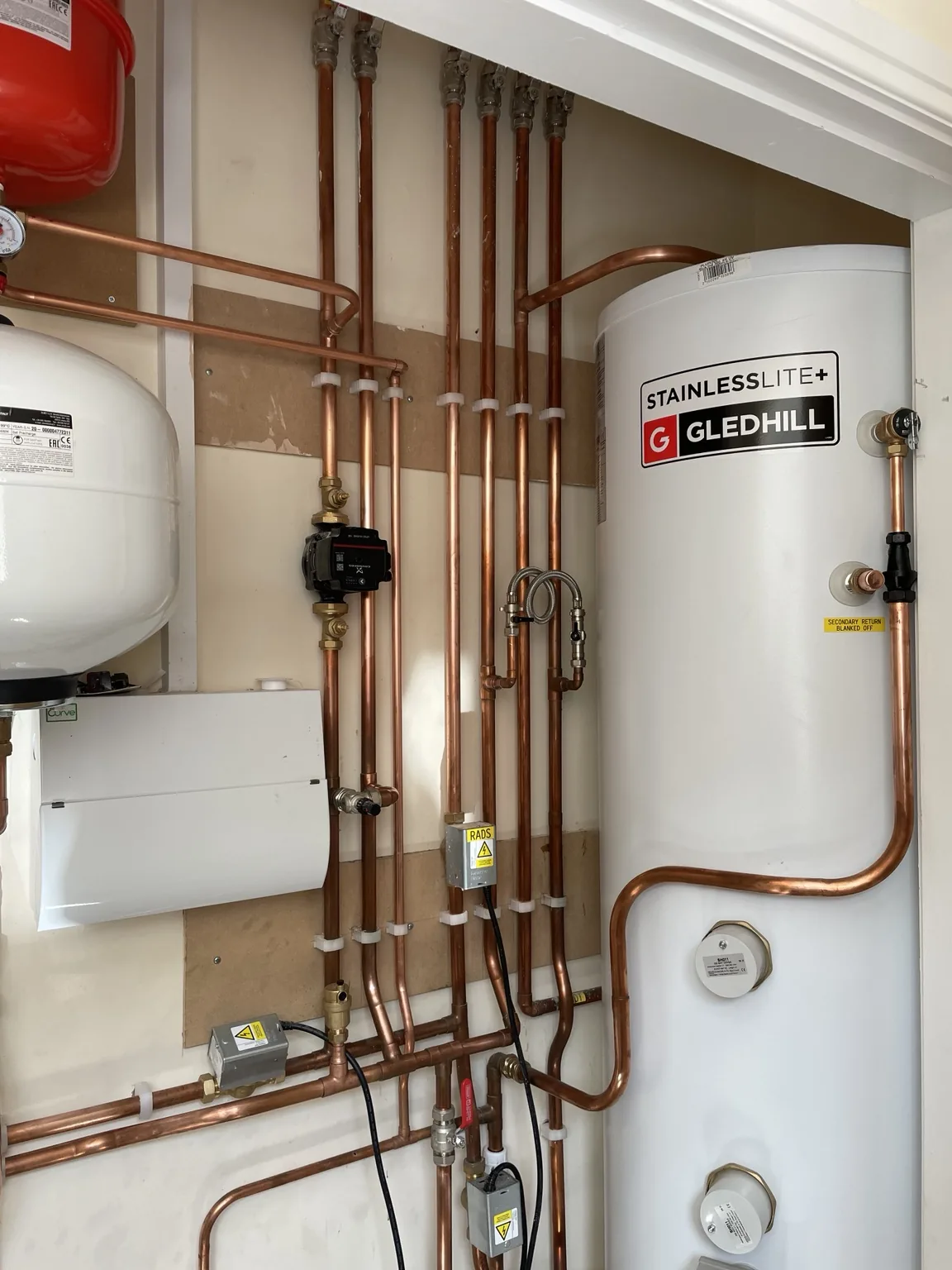 Hot water cylinder and copper pipework installation